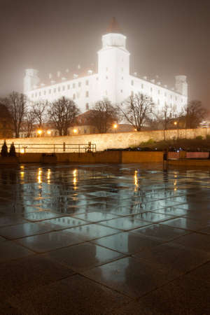 illuminated bratislava castle in the fog with reflectionsの写真素材