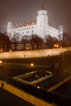 illuminated bratislava castle in the autumn mistの写真素材