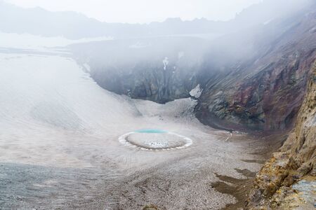 Ice lake in the crater of Gorely volcano, Kamchatka, Russia