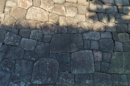 Stone gray wall for background on a bright summer day. Imperial Palace, Tokyo, Japan.の写真素材