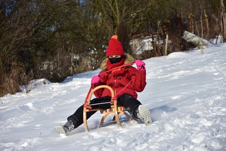 Happy Family sledding in winter on the snowの写真素材