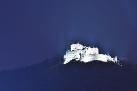 old historical ruins of castle Kapuany Slovakia lighted in the nightのeditorial素材