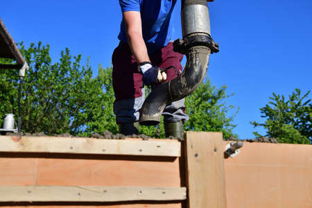 Detail of a concrete pump from which concrete is poured into walls on the construction siteの写真素材