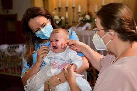 Portrait of children in church in front of altar with respirator on face