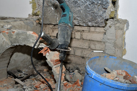 Detail of the concrete hammer and chimney outlet in the room during renovationの写真素材