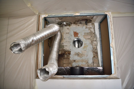 Repair of the fireplace insert and connection to the chimney in the houseの写真素材