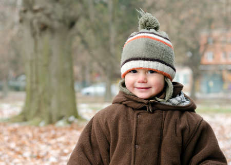 Winter portrait of happy toddler child in park.の写真素材