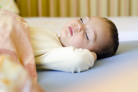 Portrait of a sleeping toddler child in bed or cot.の写真素材
