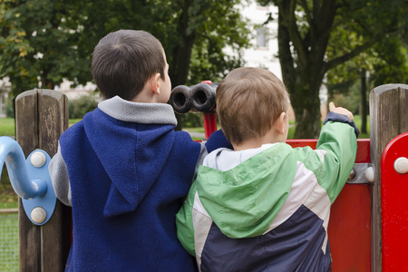Children playing at playground with toy binocularsの写真素材