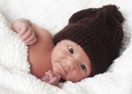 Portrait of a cute newborn baby in knitted hat.の写真素材