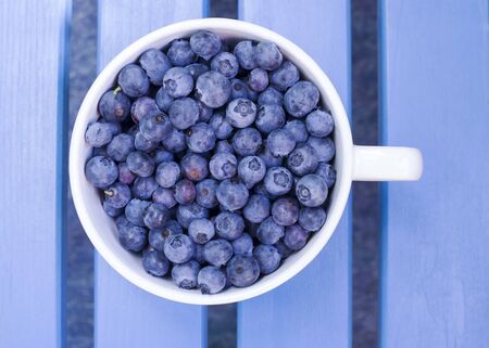Fresh blueberries in a bowl, top view.の写真素材