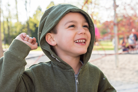 Portrait of a happy smiling child boy in a playgroundの写真素材