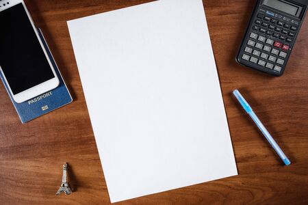 a sheet of A4 paper on the table and a passport with a pen, a sheet of A4 paper and a passport with a mobile phone, a blank A4 sheet and a passport with a pen near it, sheet of paper and calculatorの写真素材