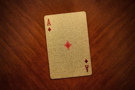 playing ace card on wooden background, ace of diamonds close up, gold, golden ace card of diamonds