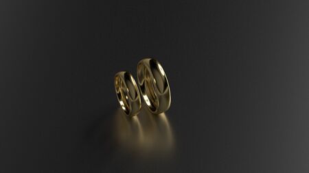 The beauty gold wedding rings on black background. 3d renderingの写真素材
