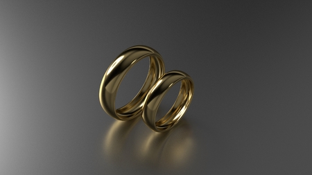 The beauty gold wedding rings on black background. 3d renderingの写真素材