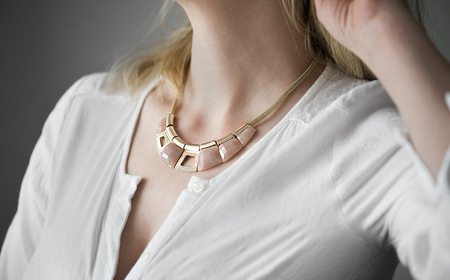 Gold necklace on woman's neck