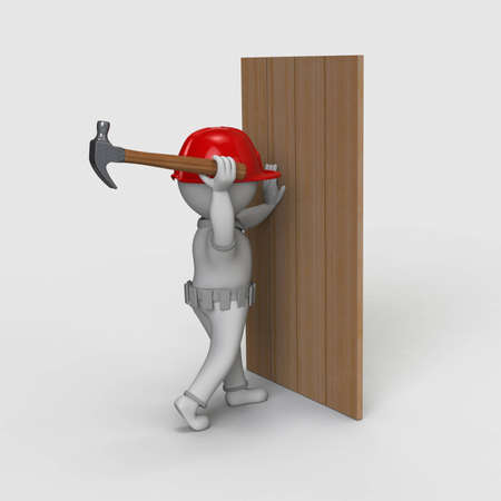 Guy sticks nails and wears a helmet on his head and is dressed for construction.の写真素材