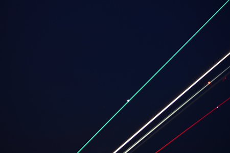 Jetliner taking off into darkening skies, light streaks, abstract
