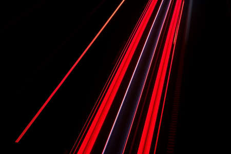 Night traffic. Streaks of tail lights on a motorway. Geometric abstract