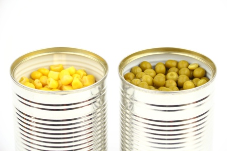 The tins with peas, corn on the white backgroundの写真素材