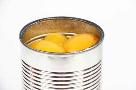 The tin with peaches  on the white backgroundの写真素材