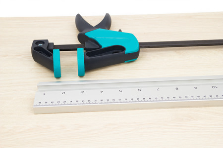 Clamp carpentry and measuring strip on the chipboardの写真素材
