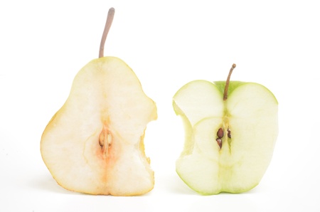 Bitten apple and pear cut in half isolated on whiteの写真素材