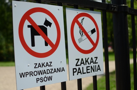 No smoking and no dogs allowed signs hanging on a fenceの写真素材