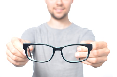 Man giving a glasses isolated on whiteの写真素材