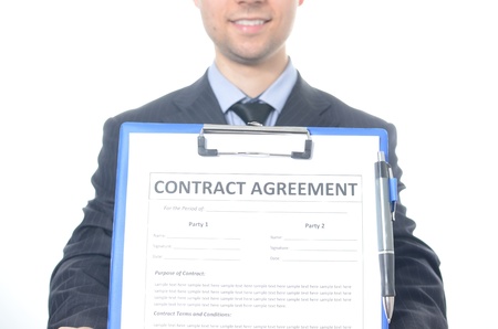 Young businessman signing a contract isolated on whiteの写真素材