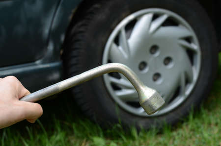 Man changing tyre in his carの写真素材