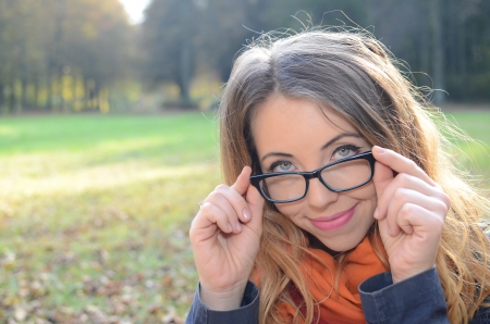 Portrait of  young woman with laptop and glasses in  parkの写真素材