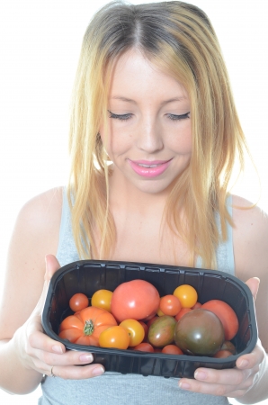 Young woman eating fresh salad isolatedの写真素材
