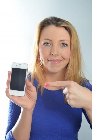 Young woman in blue dress with cell phone の写真素材