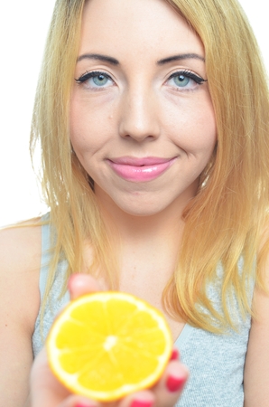 Young woman with orange slice isolatedの写真素材