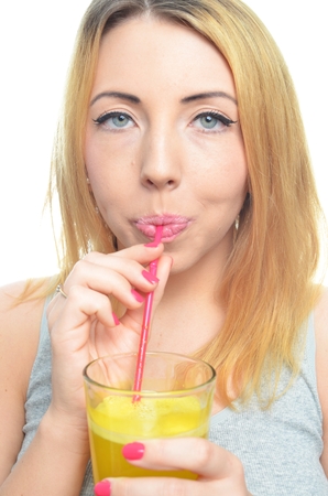 Woman drinking orange juice isolatedの写真素材