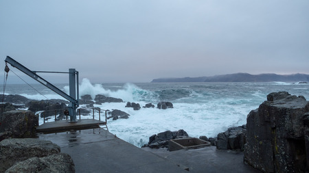 Waves crash against the rocksの写真素材