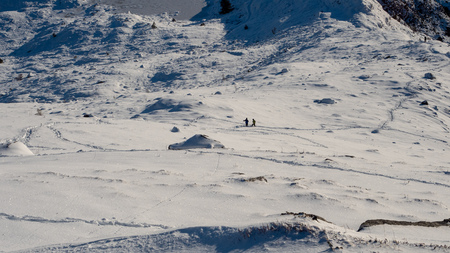 Two men talking on a mountain trailの写真素材