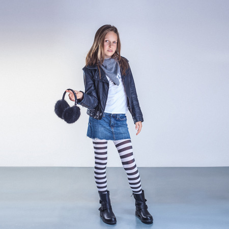 Fashionable young teenager girl posing in studio, looking at camera.の写真素材