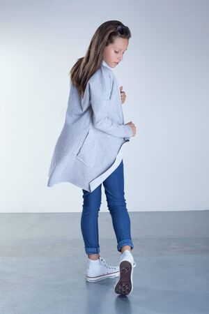 Young teenager girl posing in fashionable clothes. Studio shot.の写真素材