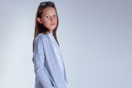 Young teenager girl posing in fashionable clothes. Studio shot.の写真素材