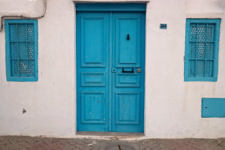 Blue wooden door on a white wall.