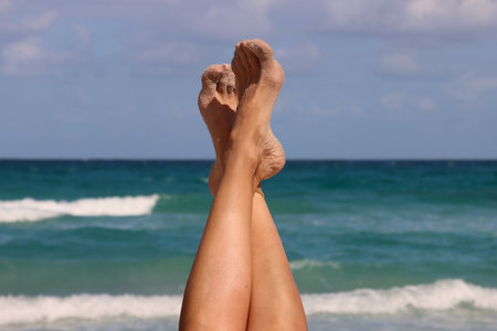 Feet of a woman on the beach, close-up.の写真素材