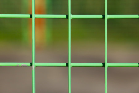 Green metal fence close up.の写真素材