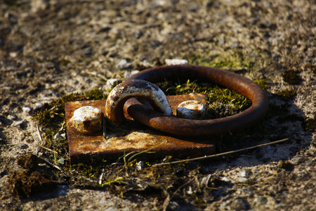 Rusty metal ring on the ground. Close-up. Selective focus.の写真素材