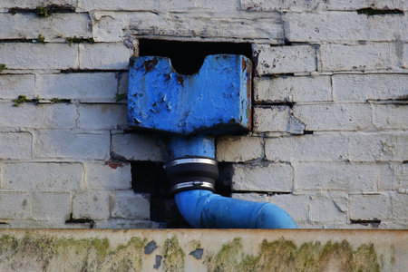 Blue water pipe on a wall of an old building, close-upの写真素材