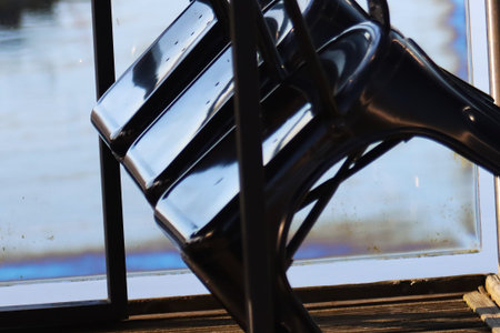 Black plastic chair on the windowsill in the morning. Selective focus.の写真素材