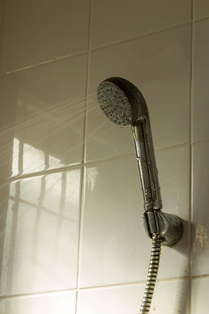 Shower with running water in bathroomの写真素材