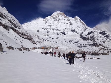 ANNAPURNA, NEPAL - APR 12 : Unidentified trekkers are walking in the mountains. Nepal, Himalayas, Annapurna region on April 12, 2013のeditorial素材
